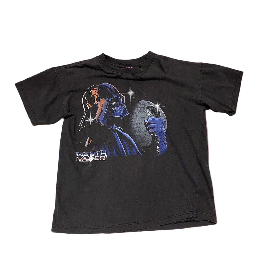 A black t-shirt with a printed graphic of Darth Vader on the front, featuring a starry background and the text 'Star Wars'.