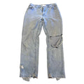 Pair of light blue jeans on a textured brown surface
