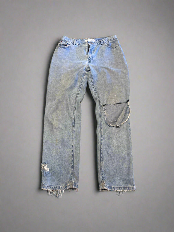 Pair of light blue jeans on a textured brown surface
