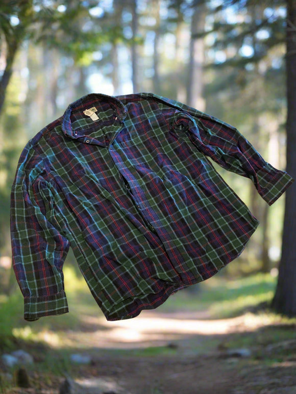 Plaid shirt on a textured beige surface