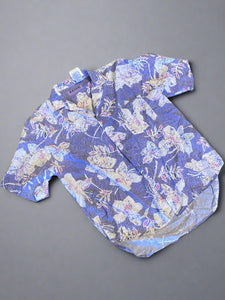 Floral-patterned pants on a concrete floor