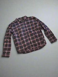 Plaid shirt on a textured concrete floor