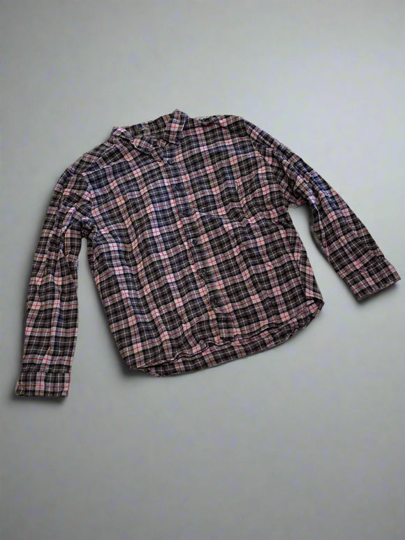 Plaid shirt on a textured concrete floor