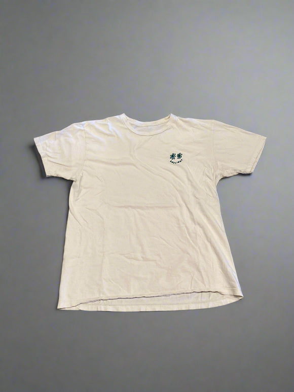 White shirt with a small design on a gray concrete surface
