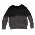 Black long-sleeve shirt on a textured beige surface