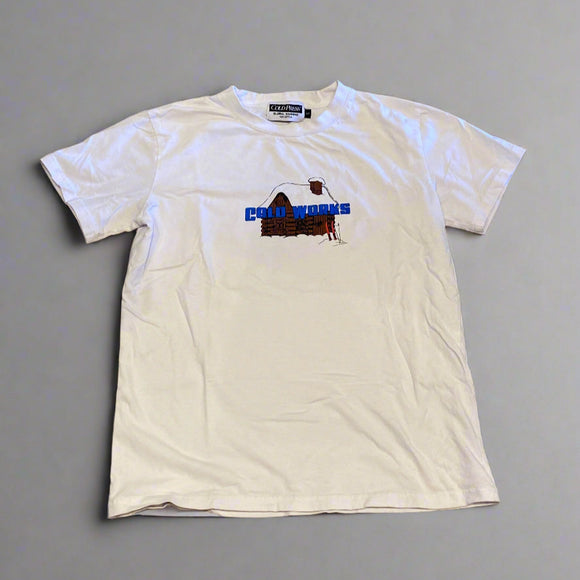 White t-shirt with a logo on a concrete floor